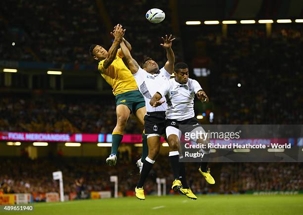 Israel Folau of Australia jumps for the ball with Metuisela Talebula and Asaeli Tikoirotuma of Fiji during the 2015 Rugby World Cup Pool A match...