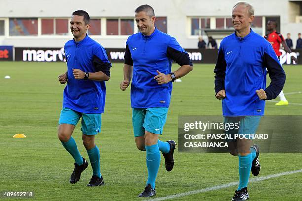 Referees Fredy Frautel , Cyril Gringore and Eric Danizan warm up before the French L1 football match GFC Ajaccio against Rennes on September 23, 2015...