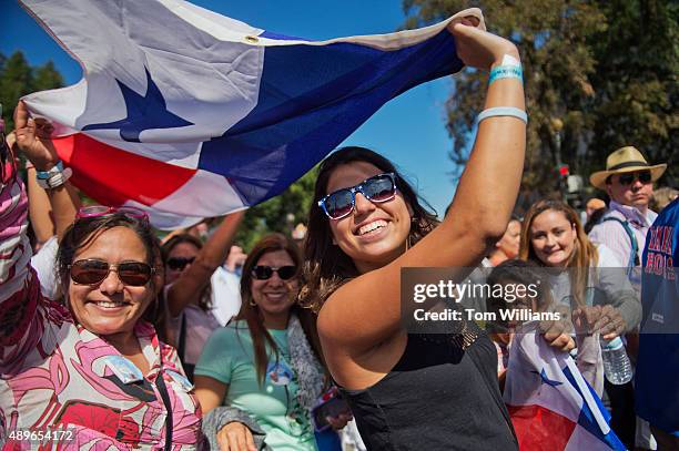 Women wave the Panamanian flag on Constitution Avenue NW, after seeing Pope Francis at a parade in his honor, September 23, 2015. Prior to the parade...