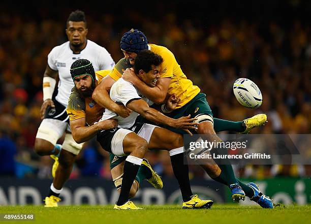 Ben Volavola of Fiji offloads in the tackle during the 2015 Rugby World Cup Pool A match between Australia and Fiji at the Millennium Stadium on...