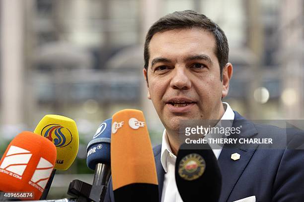 Greece's Prime minister Alexis Tsipras answers journalists' questions as she arrives to take part in a European Union emergency summit on the...