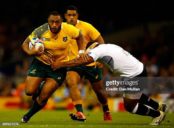 Sekope Kepu of Australia breaks past Talemaitoga Tuapati of Fiji on way to scoring his side's third try during the 2015 Rugby World Cup Pool A match...