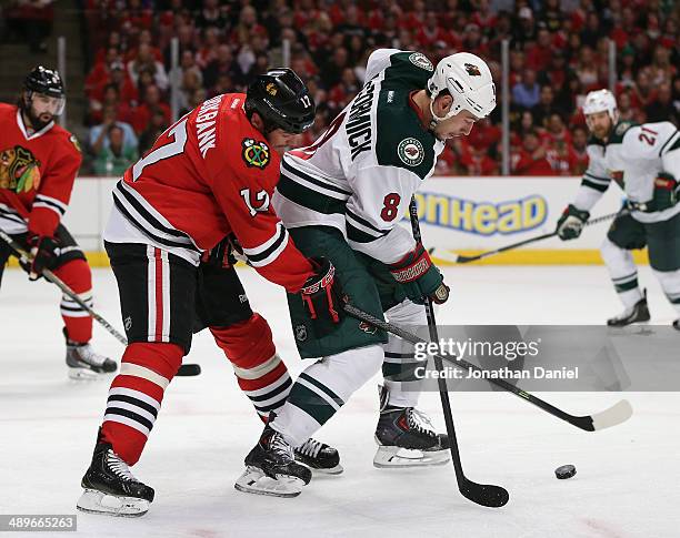 Sheldon Brookbank of the Chicago Blackhawks pressures Cody McCormick of the Minnesota Wild in Game Five of the Second Round of the 2014 NHL Stanley...