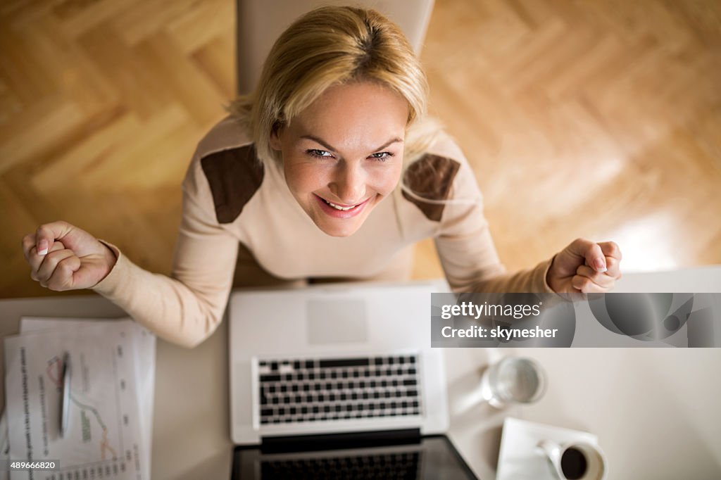 Above view of happy businesswoman celebrating her success.