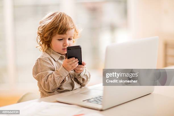 little business boy using smart phone in the office. - adult imitation stock pictures, royalty-free photos & images