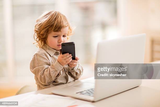 little business boy using smart phone in the office. - spela vuxen bildbanksfoton och bilder