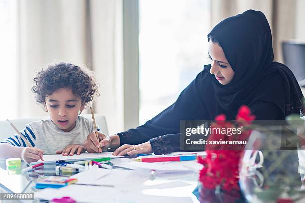 mother and son drawing at home - dubai cares stock pictures, royalty-free photos & images