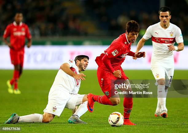 Hiroshi Kiyotake of Hannover battles for the ball with Zapata Insua of Stuttgart during the Bundesliga match between Hannover 96 and VfB Stuttgart at...