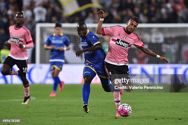 Roberto Maximilian Pereyra of Juventus FC is challenged by Raman Chibsah of Frosinone Calcio during the Serie A match between Juventus FC and...