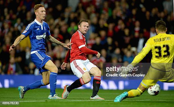 Wayne Rooney of Manchester United scores the opening goal past Bartosz Bialkowski of Ipswich Town during the Capital One Cup Third Round match...