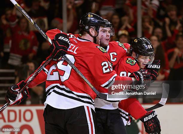 Bryan Bickell, Jonathan Toews and Partick Kane of the Chicago Blackhawks celebrate Bickell's second period goal against the Minnesota Wild in Game...