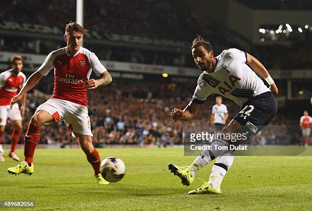 Nacer Chadli of Tottenham Hotspur crosses the ball which deflects off of Calum Chambers of Arsenal for an own goal for Spurs' first goal during the...