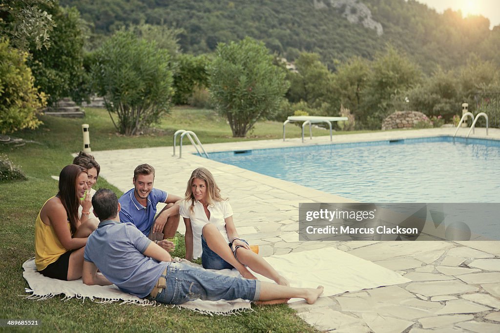 Group of friends on holiday by the pool