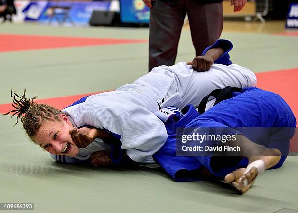 Lucie Perrot of France screams with joy after winning the u70kg bronze medal while holding down Stessie Bastareaud of France during the London...