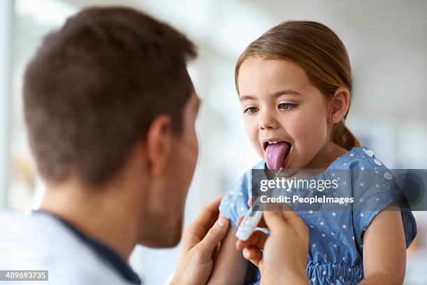 stick out your tongue - girl tongue doctor stockfoto's en -beelden