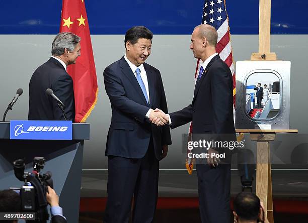 Chinese President Xi Jinping shakes hands with Dennis Muilenburg , President and CEO of the Boeing Company and watched by Ray Conner , President and...