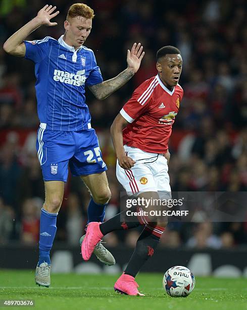 Manchester United's French striker Anthony Martial controls the ball ahead of Ipswich Town's Welsh defender Josh Yorwerth before scoring his team's...