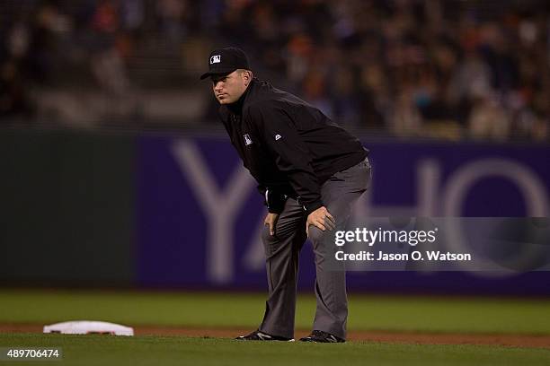 Umpire Andy Fletcher stands on the field during the first inning between the San Francisco Giants and the Cincinnati Reds at AT&T Park on September...