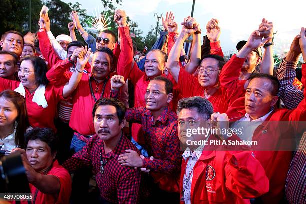 Pro-government 'red shirts' leaders cheer during a large rally on the outskirts of Bangkok. The government supporters massed on the outskirts of...