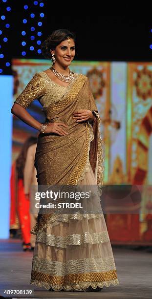 Indian television actress Parizad Kolah displays a creation by designer Vikram Phadnis during a fashion show fundraiser for cancer in Mumbai late May...