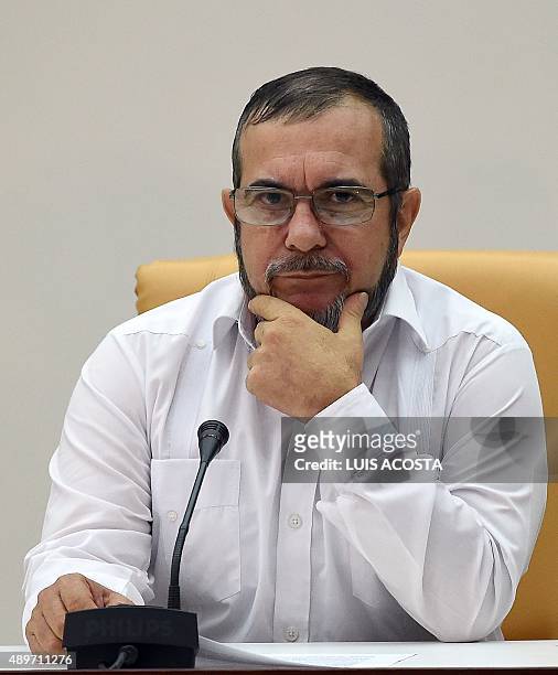 The head of the FARC guerrilla Timoleon Jimenez, aka Timochenko attends a meeting with Colombian President Juan Manuel Santos in Havana on September...