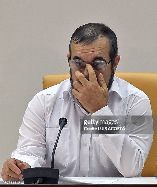 The head of the FARC guerrilla Timoleon Jimenez, aka Timochenko gestures as he attends a meeting with Colombian President Juan Manuel Santos in...