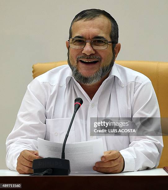 The head of the FARC guerrilla Timoleon Jimenez, aka Timochenko speaks during a meeting with Colombian President Juan Manuel Santos in Havana on...