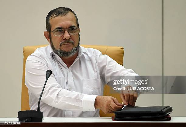 The head of the FARC guerrilla Timoleon Jimenez, aka Timochenko speaks during a meeting with Colombian President Juan Manuel Santos in Havana on...