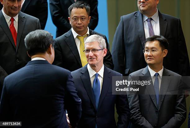 Chinese President Xi Jinping shakes hands with Apple CEO Tim Cook as Tencent's Pony Ma looks on during a gathering of CEOs and other executives at...