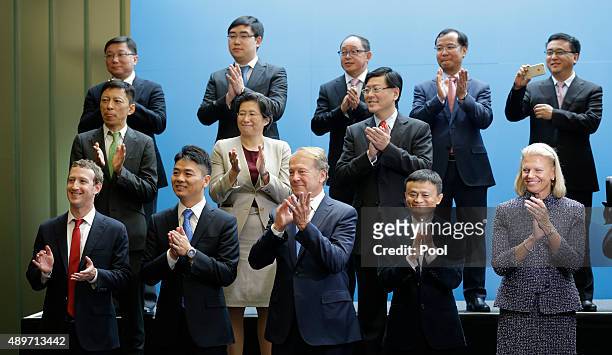 Group of CEOs and other executives applaud as Chinese President Xi Jinping arrives to greet them and pose for a photo at Microsoft's main campus...