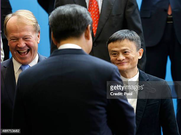 Chinese President Xi Jinping, center, is greeted by Cisco CEO John Chambers, left, and Alibaba Executive Chairman Jack Ma, right, during a visit at...
