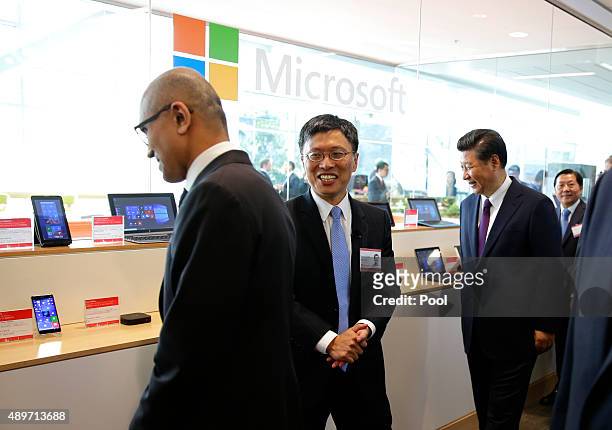 Harry Shum, center, Microsoft Executive Vice President of Technology and Research, and Microsoft CEO Satya Nadella, left, show Chinese President Xi...
