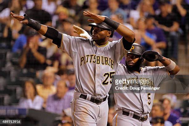 Gregory Polanco and Josh Harrison of the Pittsburgh Pirates celebrate after scoring on a double by Starling Marte of the Pittsburgh Pirates off of...