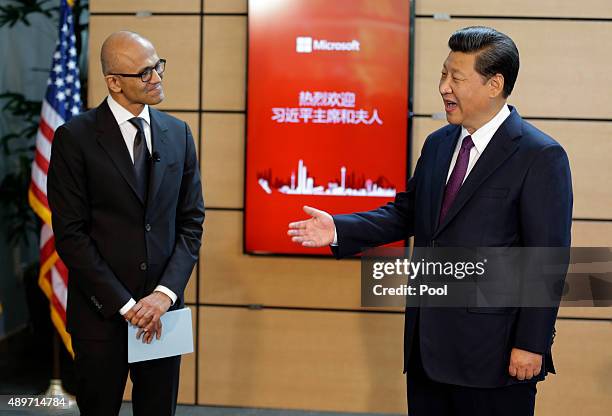 Chinese President Xi Jinping talks with Microsoft CEO Satya Nadella during a tour of the main campus of Microsoft September 23, 2015 in Redmond,...