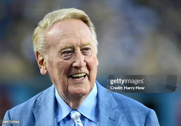 Los Angeles Dodgers broadcaster Vin Scully smiles on the field before the game against the Arizona Diamondbacks at Dodger Stadium on September 23,...