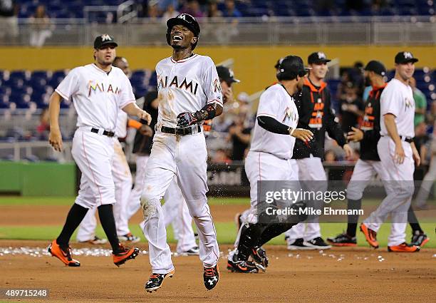 Dee Gordon of the Miami Marlins is congratulated after hitting a walkoff double in the 11th inning during a game against the Philadelphia Phillies at...