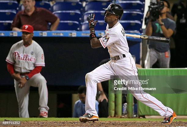 Dee Gordon of the Miami Marlins hits a walkoff double in the 11th inning during a game against the Philadelphia Phillies at Marlins Park on September...