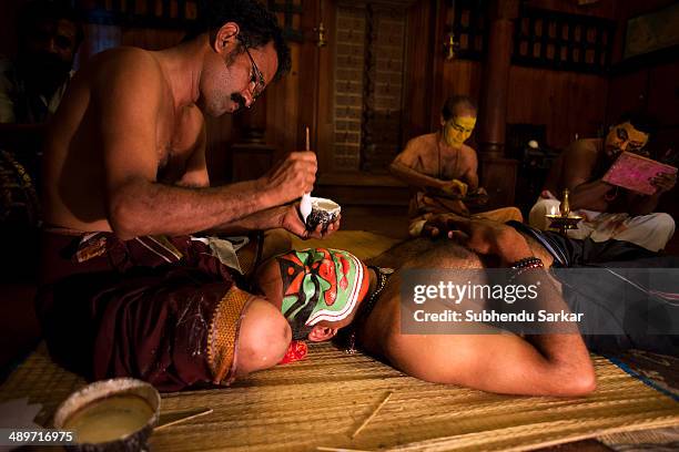 Kathakali dancers undergoing make-up before a show in Fort Kochi. Kathakali is a highly stylized classical Indian dance-drama noted for the...