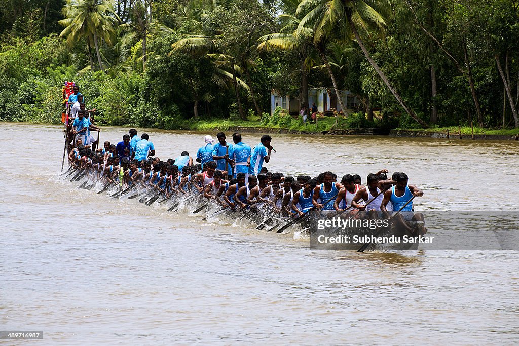 Men row a snake boat during Paipad Boat race...