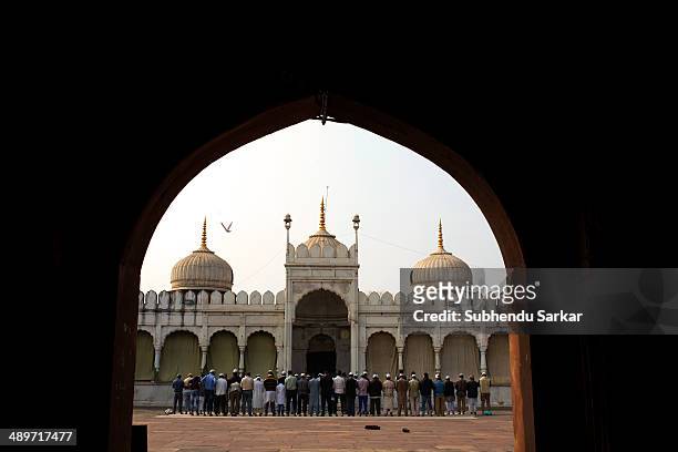 Muslims offer prayer at Moti Masjid. The Moti Masjid was built in 1860 by Sikandar Jehan Begum. The mosque has a marble-white façade with two small...