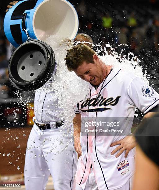 Justin Upton of the San Diego Padres dumps ice over Jedd Gyorko, right, #9 of the San Diego Padres after Gyorko hit a walk-off single during the...