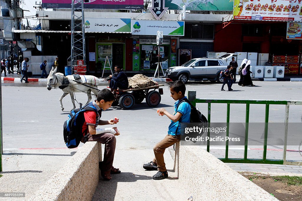 Palestinian boys sit in a street in Rafah in the southern...