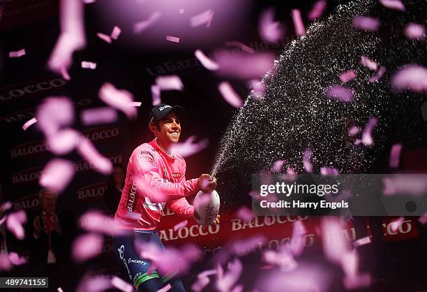 Michael Matthews of Australia and team Orica-GreenEDGE sprays champagne in celebration after retaining the Maglia Rosa jersey following the third...