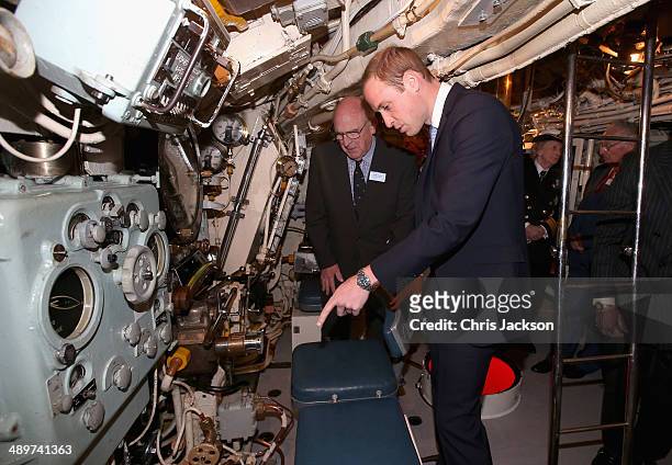 Prince William, Duke of Cambridge is shown the inner workings of the Submarine HMS Alliance as he arrives at the Royal Navy Submarine Museum on May...