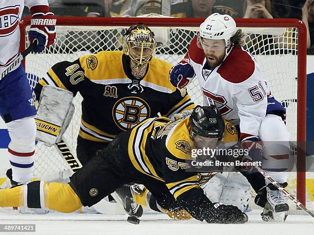 Johnny Boychuk of the Boston Bruins battles with David Desharnais of the Montreal Canadiens during Game Five of the Second Round of the 2014 NHL...