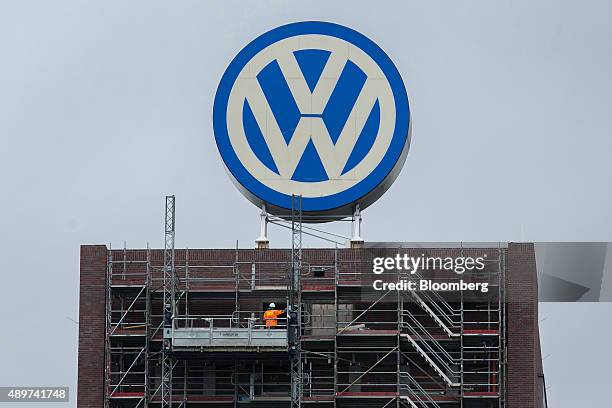 Scaffolding surrounds a building under construction as the VW logo stands above at the Volkswagen AG headquarters in Wolfsburg, Germany, on...