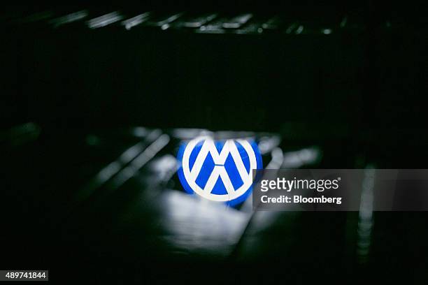 Puddle reflects the VW logo at night outside the Volkswagen AG headquarters in Wolfsburg, Germany, on Wednesday, Sept. 23, 2015. Volkswagen's...
