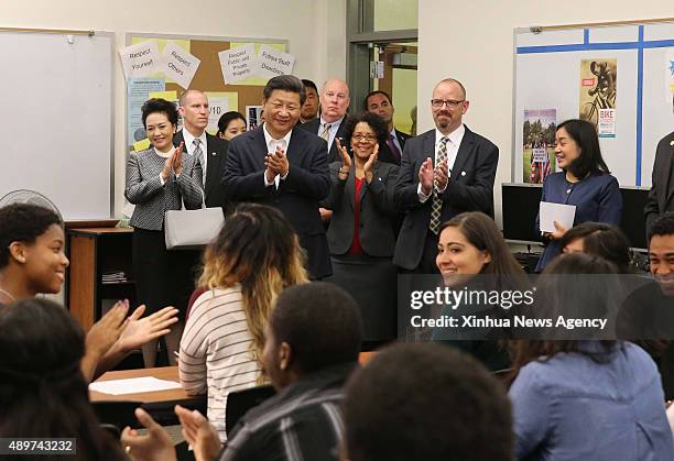Sept. 23, 2015: Chinese President Xi Jinping, back fourth right, and his wife Peng Liyuan, back second left, greet teachers and students during their...
