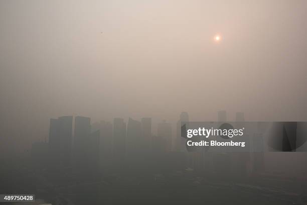The city skyline at Marina Bay as buildings in the central business district stand shrouded in smog in Singapore, on Thursday, Sept. 24, 2015. The...