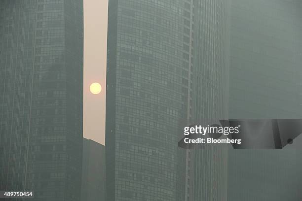 Buildings in the central business district stand shrouded in smog in Singapore, on Thursday, Sept. 24, 2015. The haze from Indonesian forest fires...
